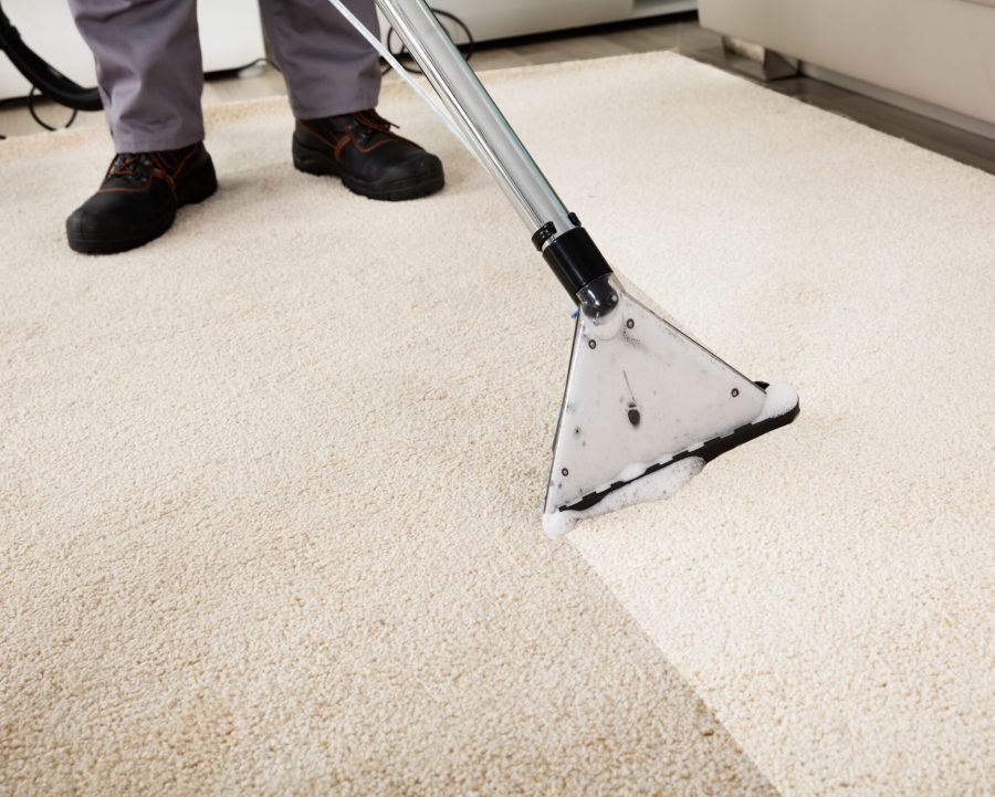 Person Cleaning Carpet With Vacuum Cleaner Vaughan Furniture Cleaning