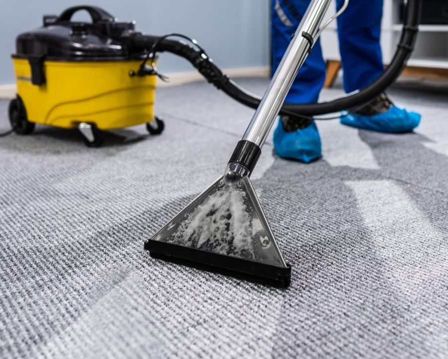 Photo Of Janitor Cleaning Carpet With Vacuum Cleaner